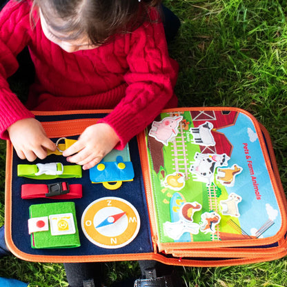Montessori busy book for toddlers with buckles, zippers and laces for screen-free play. Supports development of fine motor skills.